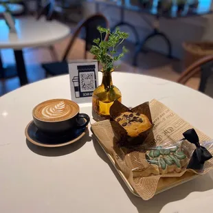 a cup of coffee and a muffin on a table