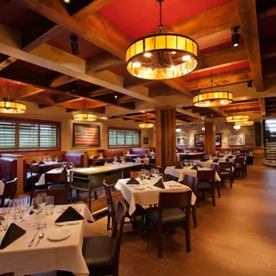 The dining room incorporates antique mirrors and light fixtures and handmade stained glass pieces.