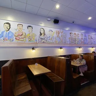 a restaurant with a mural on the wall