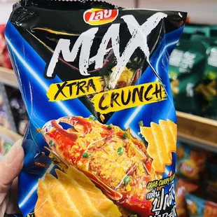 a hand holding a bag of nachos