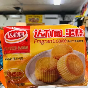 a hand holding a package of muffins