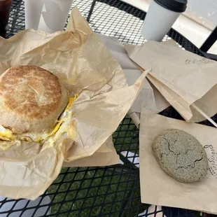 Latte and cold brew with brown sugar syrup, tomato egg breakfast sandwich, veggie quiche, and blue corn cookie