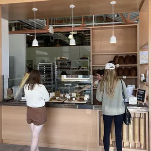two women standing in front of a counter