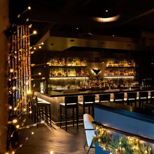 a dimly lit bar with christmas lights