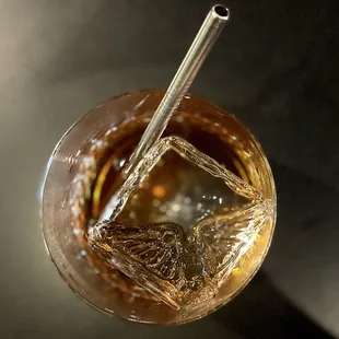 a glass of iced tea with a straw