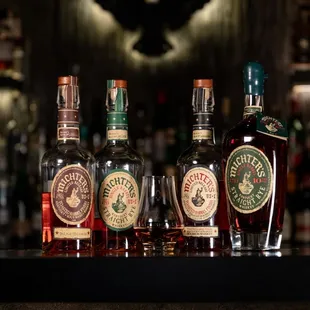 a variety of liquor bottles on a bar counter