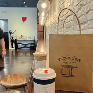 a cup of coffee and a paper bag