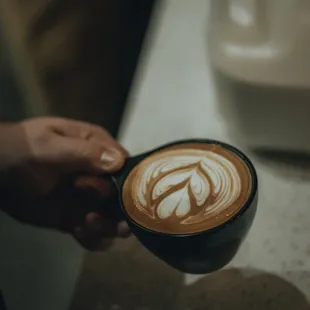 a person holding a cup of coffee