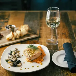 a plate of food and a glass of wine