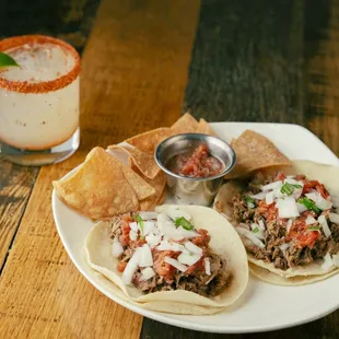 a plate of tacos and a drink