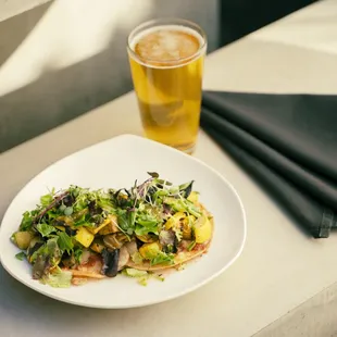 a plate of food and a glass of beer