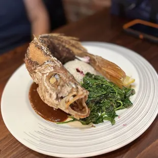 Fried red snapper, rice and spinach.