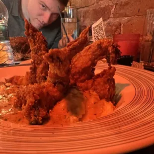 a man sitting at a table with a plate of food