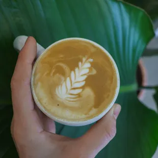 a person holding a cup of coffee