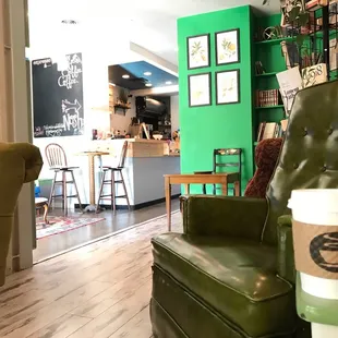 a green chair and a coffee cup