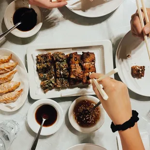 a table full of food and chopsticks