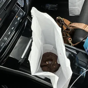 this is a photo of my doughnut tossed in the bag and the other bag on the floor has my other two donuts