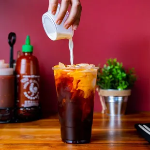 a person pouring a drink