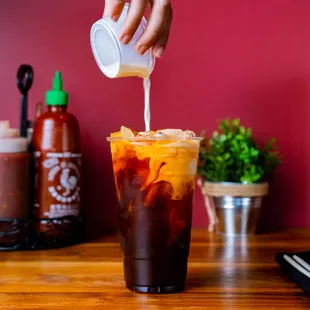 a person pouring a drink