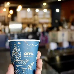 Small to-go cup with counter in background.