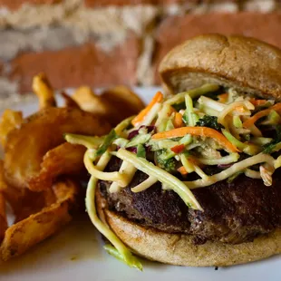 a burger with coleslaw and fries