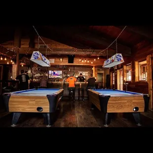 two pool tables and a bar