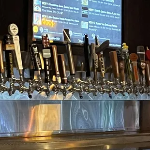 a row of beer taps on a bar