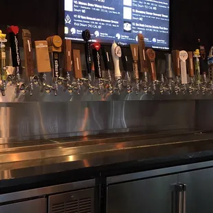 a row of beer taps on a bar