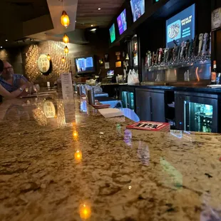 the bar counter and the televisions