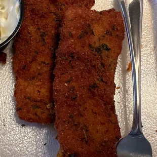 fried fish fillets with a side of sour cream