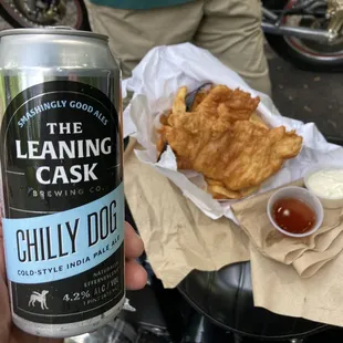 a person holding a can of leaning cask
