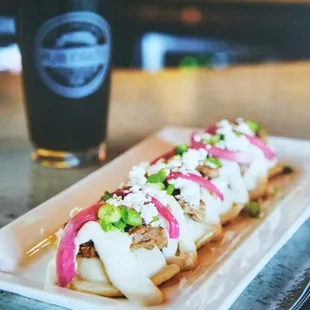 a plate of food and a glass of beer