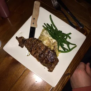 The petite strip with mash and green beans: only $10.99 on steak night!