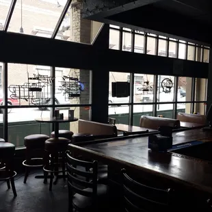 tables and chairs in front of large windows