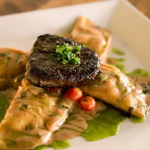 Short Rib Ravioli topped with a cut of beef tenderloin