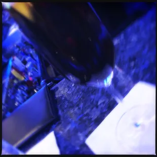 a glass of wine being poured into a wine glass