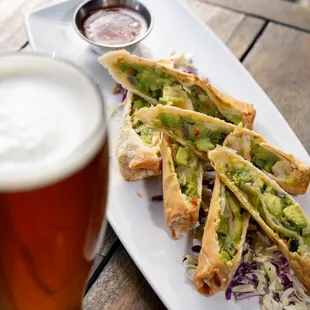 Avocado Eggrolls:
Black beans, cheese sauce, peppers, cilantro, thai chili sauce