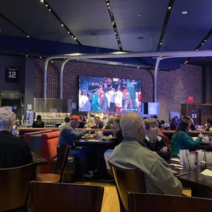 people sitting at tables in a restaurant