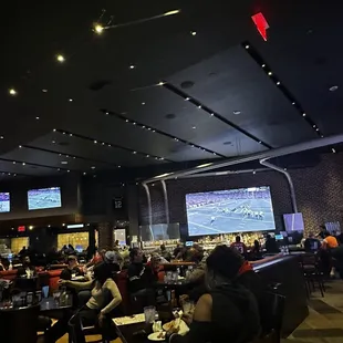 people sitting at tables in a restaurant