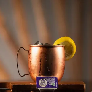 a copper mug with a lemon wedge in it