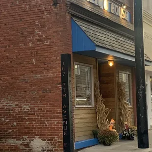 a brick building with a blue awning