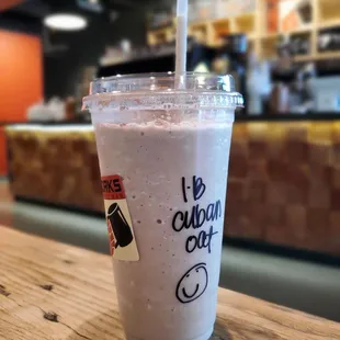 a cup of coffee with a straw