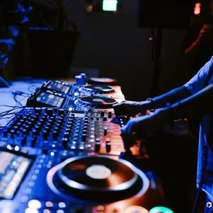 a dj mixing music in a dark room