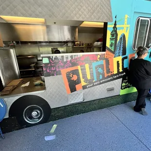 a man standing in front of a food truck