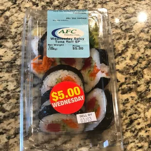 a plastic container of sushi
