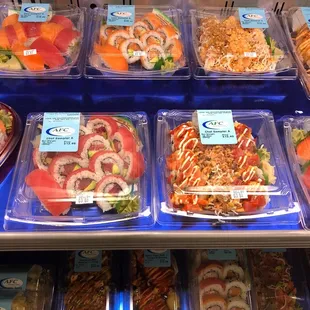 a display of sushi and other foods