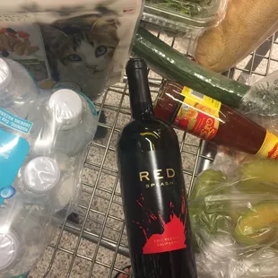 a bottle of red wine and bottles of beer