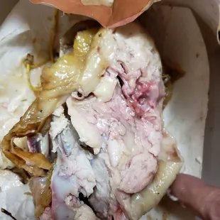 a half eaten sandwich in a wrapper