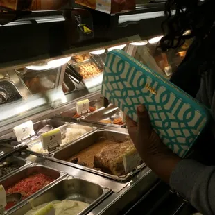 a woman reaching for a bag of food