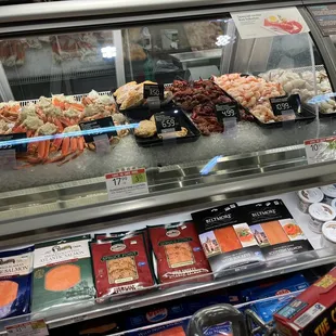 a variety of seafood items in a display case